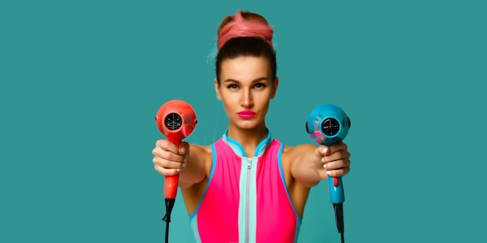 Woman holding two hair dryers